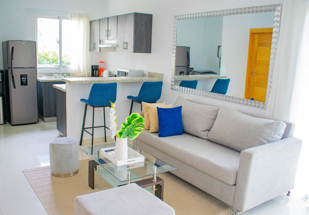 A view of the living room and kitchen in an apartment in the Beach Apartamentos complex at Playa Palmera Beach Resort. 